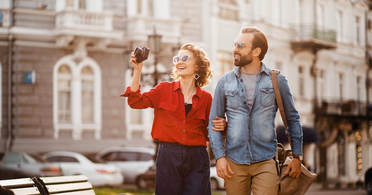 Couple travelling together in old city, fall hues.